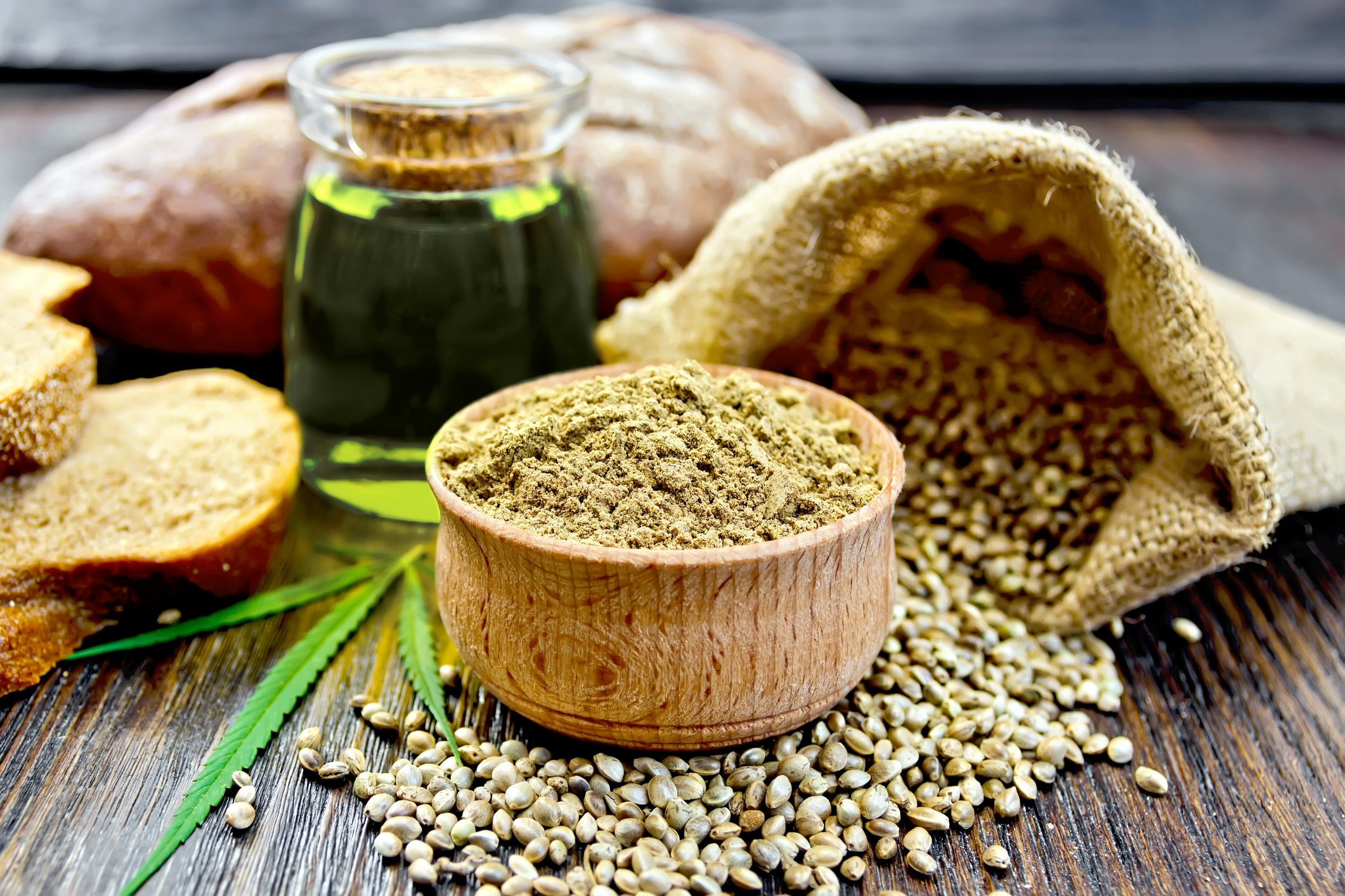 Hemp seeds, oil, and powder on table.