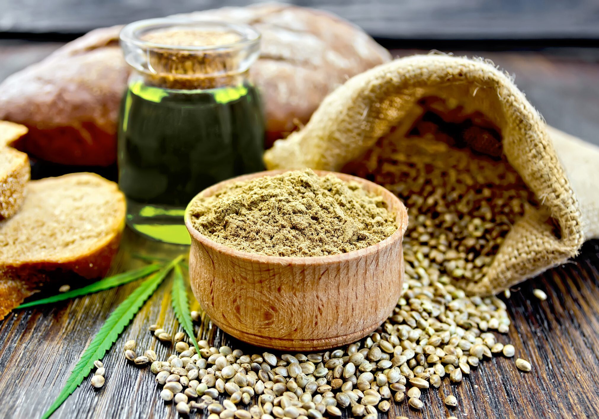 Hemp seeds, oil, and powder on table.
